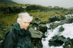 picture of walker listening to the sound of a stream rushing by in full flow